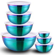 five bowls with lids stacked on top of each other in blue and green colors,