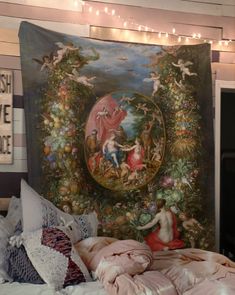 a large tapestry hanging on the wall above a bed