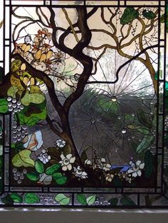 a stained glass window with an umbrella and flowers in the rain, behind it is a tree