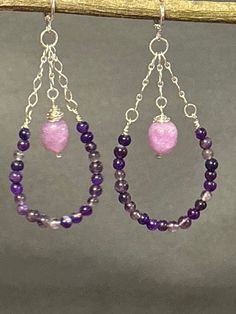 Artisan designed and handcrafted making these earrings are one of a kind. Purple and lavender amethyst wire wrapped beads. These earrings are dangling down the sterling silver chain. These purple amethyst are making a bead hoop. Lavender amethyst large beads are wire wrapped and dangling on a sterling silver chain attached to the lever back earring wire. This pair of earrings are a great presentation of a hoop earring. These earrings are a perfect gift. Total measurement 3 inches long including Purple Gemstone Bead Dangle Earrings, Purple Gemstone Beads Dangle Earrings, Purple Dangle Earrings With Gemstone Beads, Purple Gemstone Chandelier Drop Earrings, Purple Gemstone Chandelier Earrings, Purple Gemstone Chandelier Earrings For Gift, Handmade Purple Chandelier Earrings As Gift, Purple Teardrop Chandelier Earrings As Gift, Bohemian Purple Chandelier Earrings With Ear Wire