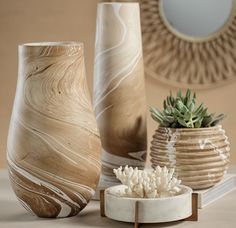 three vases sitting on top of a table next to each other with succulents in them