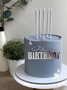 a blue birthday cake sitting on top of a table