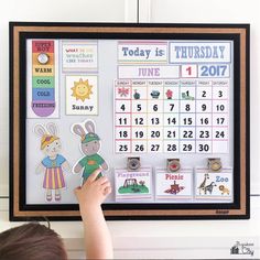 a young child is holding up a calendar