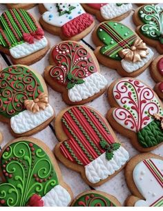 decorated christmas cookies are displayed on a table