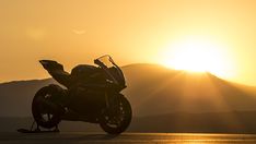 a motorcycle is parked in front of the sun