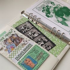 a binder with many pictures on it sitting next to a clipboard and some papers