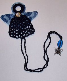 a crocheted hat with a star on it and a blue bead necklace