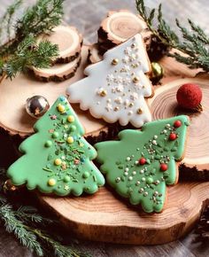 decorated christmas cookies sitting on top of a wooden board