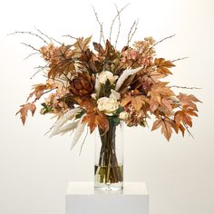 a vase filled with lots of different types of flowers