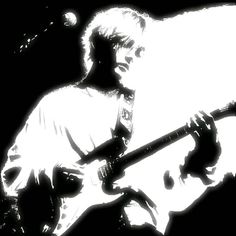 a black and white photo of a man playing an electric guitar