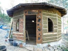 a small wooden structure sitting on top of a dirt field