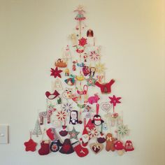 a christmas tree made out of magnets on the wall