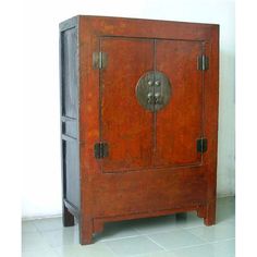 an old wooden cabinet with two doors on one side and a metal door on the other