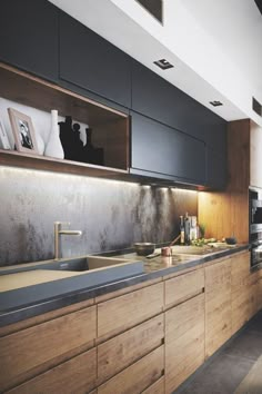 a kitchen with wooden cabinets and stainless steel counter tops is pictured in this image, there are pictures on the wall above the sink