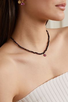 Andrea Fohrman's necklace is strung with black Ethiopian beads and a dangling rhodolite garnet pendant that's topped with a diamond-encrusted star. It's handmade from 14-karat rose gold and has a short length that's perfect for layering with the brand's longer styles. Black Spinel Round Beads Jewelry For Gifts, Gift Black Spinel Round Bead Jewelry, Elegant Black Spinel Jewelry With Faceted Beads, Luxury Black Beads Jewelry For Gift, Elegant Jewelry With Garnet Natural Stones, Luxury Black Bead Jewelry For Gift, Elegant Jewelry With Garnet And Natural Stones, Elegant Garnet Jewelry With Natural Stones, Elegant Tourmaline Beaded Necklaces With Round Beads