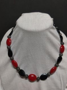 "Proudly display your love and support of your favorite red and black team.  This one of kind necklace includes red and black beads with easy close toggle clasp.  The necklace is 21\" in length.  This beautiful original will be a fine addition to your team spirit collection!" Adjustable Red And Black Beaded Necklace, Adjustable Red Necklace With Black Beads, Adjustable Red Beaded Necklace With Black Beads, Adjustable Red Necklaces With Oval Beads, Adjustable Red Jewelry With Black Beads, Adjustable Red Necklace With Oval Beads, Handmade Black Necklaces With Oval Beads, Handmade Black Necklace With Oval Beads, Red Necklace With Black Beads For Gift