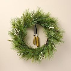 a wreath with two bells hanging from it