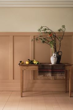 a wooden table topped with a vase filled with flowers