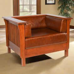 a brown leather chair sitting on top of a carpeted floor