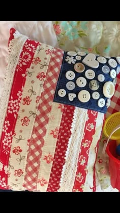 a red white and blue pillow with buttons on it