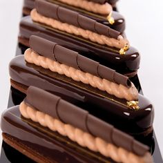 there are many chocolate desserts stacked on top of each other