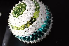 an ornament made out of white and green beads