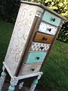 an old dresser is painted white and blue