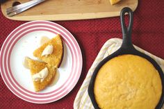 two plates with food on them next to a cutting board and utensil holder