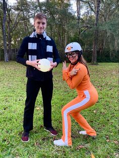 a man and woman in sports gear posing for a photo with a frisbee