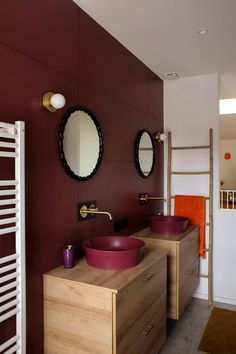 a bathroom with two sinks and mirrors on the wall