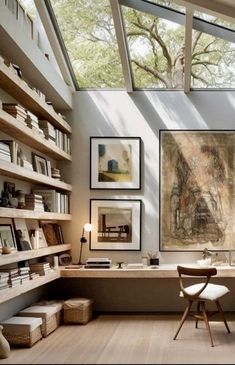 a room with bookshelves and pictures on the wall, along with a desk