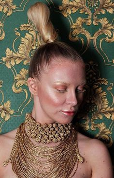 a woman with gold jewelry on her neck