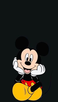 mickey mouse sitting in the dark with his hands on his head and legs crossed out