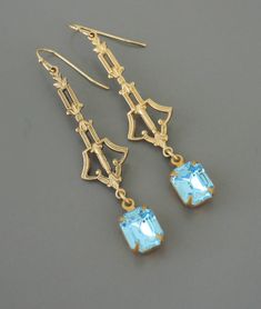 "Vintage Jewelry - Vintage Earrings - Art Deco Jewelry - Pastel Blue Earrings - Rhinestone Earrings - Brass Jewelry - Bridal Earrings Gorgeous vintage brass Art Deco earrings embellished with beautiful pastel blue vintage rhinestones. Perfect Bridesmaid earrings for your vintage wedding. Chloe says, \"Wear them and feel fabulous!\" They measure 2 1/2\" long from the top of the ear wire. Thanks for visiting Chloe's" Blue Art Deco Wedding Earrings, Art Deco Blue Drop Earrings, Blue Art Deco Drop Earrings, Blue Victorian Earrings For Wedding, Victorian Blue Earrings For Weddings, Vintage Inspired Earrings, Emerald Green Earrings, Brass Art, Vintage Jewelry Earrings