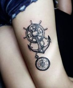 an anchor and compass tattoo on the arm