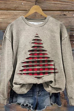 a gray sweater with red and black designs on it