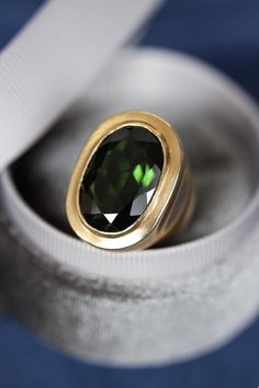 Vintage one-of-a-kind handcrafted solid 18k yellow gold bezel set ring featuring a very impressive natural green tourmaline gemstone in the center. The tourmaline is a deep rich green with a total carat weight of 11.65 carats measuring 20mm x 13mm. Ring size 6 1/2. The gold has a beautiful vintage brushed finish and was beautifully handcrafted in solid heavy 18k yellow gold. Hallmarked 18ct.  Your ring will arrive beautifully packaged with complimentary delivery via DHL express. Tracked, insured Gold Ring Unique, Gold Hat, Green Tourmaline Ring, Vintage Brush, Bezel Set Ring, Ring Bezel, Rich Green, Set Ring, 18k Yellow Gold Ring