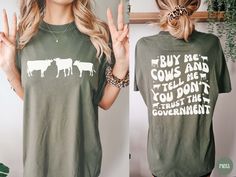 Hello friend! This retro "Buy me Cows and Tell me You Don't Trust the Government" front and back design is made on a Comfort Colors® - Unisex short sleeve crew neck tee. You'll be sure to LOVE the quality and its soft-washed, garment-dyed, extra cozy fabric! The double-needle stitching throughout the tee makes it highly durable while the lack of side-seams helps the shirt retain its tubular shape. It's the perfect tee for all your homesteading activities or to sport at your local farmer's market Farm Tshirt Ideas, Homesteading Activities, Homestead Compound, 4h Shirts, Homestead Shirt, Farmers Market Shirt, Farm Clothes, Gifts For Farmers