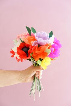 a person holding a bunch of flowers in their hand