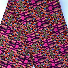 an african print shorts with geometric designs on the side and pink, blue, green, yellow