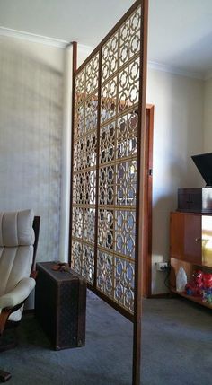 a room divider in an office with a chair and suitcase