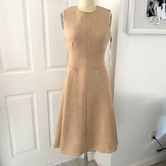 An Elegant Design With Solid, Versatile Looks. This Sleeveless Dress Is Made With Scuba-Like Stretch And Sueded Fabric, A Back Zip Closure And A Flared A-Line Silhouette. Scuba-Like Stretch For Maximum Comfort With Velvety Suede Crewneck + Sleeveless Back Zip Closure A-Line Silhouette Dry Clean 90% Polyester 10% Spandex Fitted Taupe V-neck Dress, Calvin Klein Fitted A-line Mini Dress, Elegant Calvin Klein Sleeveless V-neck Dress, Black Bell Sleeve Dress, Beige V-neck Mini Dress With Button Closure, Dress Logo, Calvin Klein Casual V-neck Dress, Pink Sheath Dress, Bell Sleeve Shift Dress