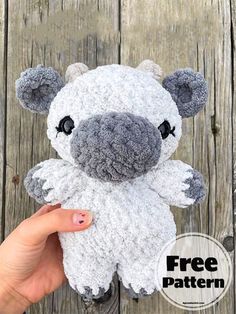 a hand holding a small stuffed animal in front of a wooden background with the text free pattern