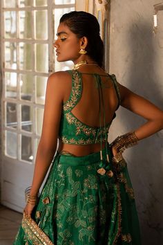 Emerald green self woven Russian jacquard lehenga with floral and animal motifs highlighted with embroidery. Comes with embroidered, padded blouse and tissue base dupatta with antique gold resham and embellished hand work. 
Components: 3
Pattern: Woven, Embroidered
Type Of Work: Floral and Animal Patterns, Resham Work
Neckline: Scoop
Sleeve Type: Sleeveless
Fabric: Lehenga and blouse : Russian Jacquard, Dupatta : Tissue
Color: Emerald Green
Other Details: 
Lehenga:
Attached lining
Embroidered hi Emerald Green Lehenga, Jacquard Lehenga, Paulmi And Harsh, Intricate Mirror, Lehenga And Blouse, Blouse Yoke, 1950’s Fashion, Lime Yellow, Green Lehenga