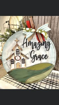 a glass ornament with the words amazing grace in black and white on it