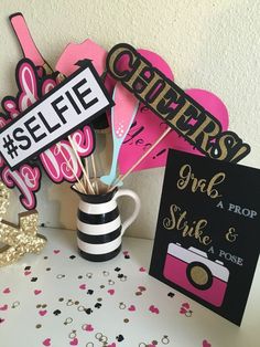 a table topped with lots of pink and black decorations