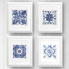 four framed blue and white artwork pieces