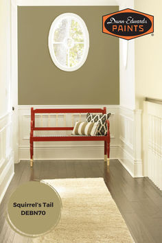 a red bench sitting in front of a round window