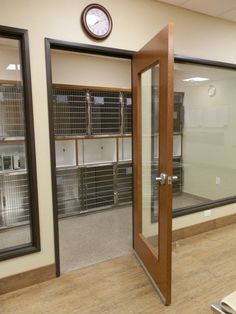 an empty room with several shelves and a clock on the wall