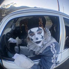 a person in a car with clown makeup on